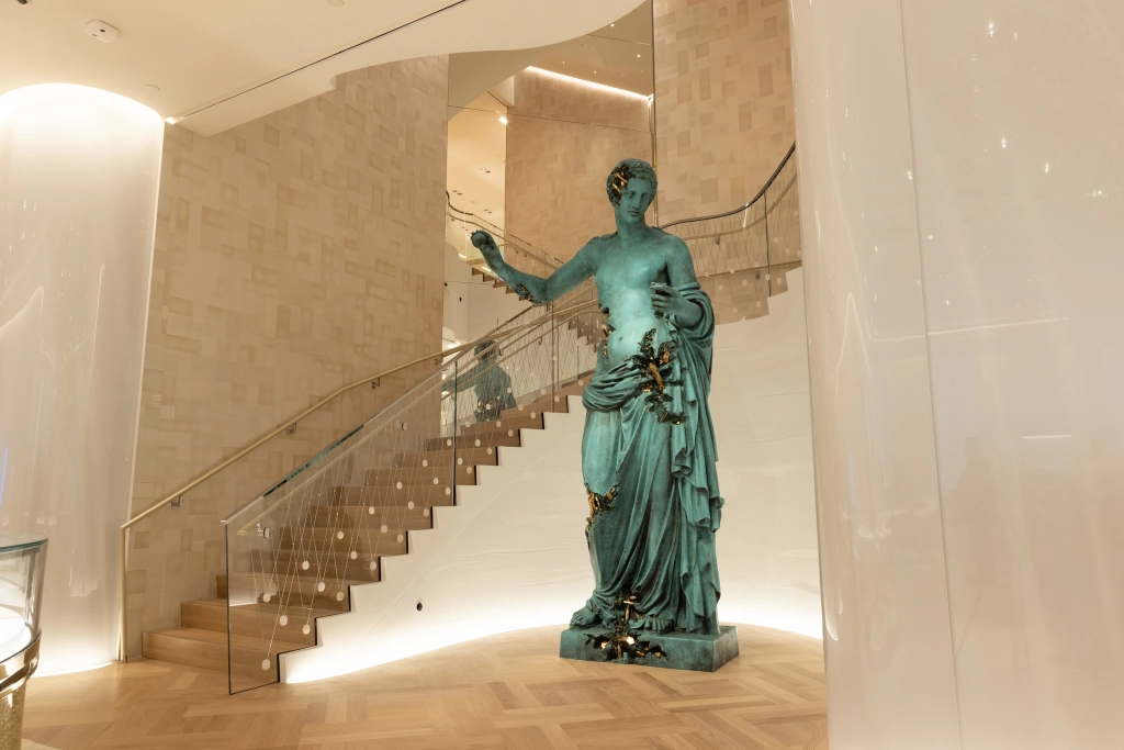 Daniel Arsham's Venus of Arles sculpture at the base of Landmark's spiral staircase, which begins on the third floor.
